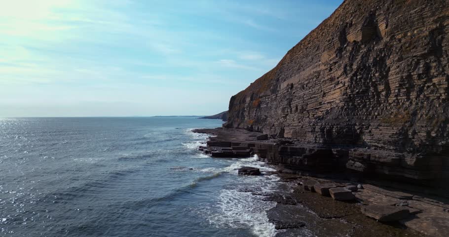 Majestic Rock Cliffs of Dunraven Bay in Wales – Rugged Coastal Landscape | 4K Footage