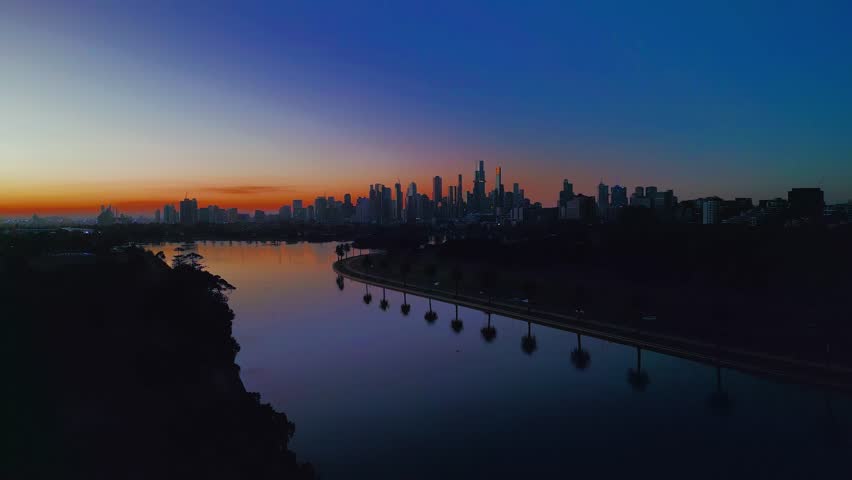 Aerial Sunset footage of the city of Melbourne from the Albert Park Lake.