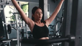 Determined athletic woman performing lat pulldown exercise, strengthening back muscles with focused effort in fitness center training environment - Powered by Shutterstock - Get 15% off with code: PIKWIZARD15