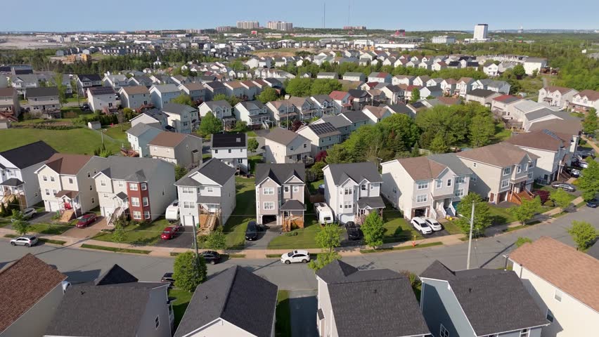 Aerial View Captures A Beautiful Contrast Of Modern Architecture And Natural Elements Like Trees And Lawns In A Suburban Area Of Nova Scotia. Over Halifax Houses Surrounded By Nature And Trees