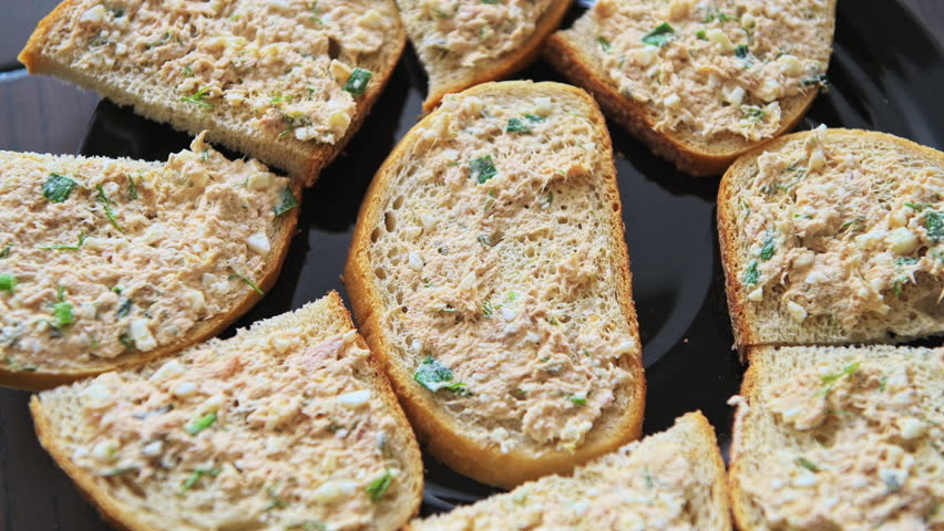 Tuna salad sandwich on black plate in kitchen, homemade food macro closeup flat top lay view