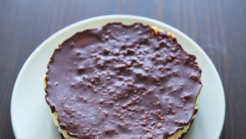 Chocolate cheesecake cream sernik Polish cake with peanut nut, cookie crust macro closeup, homemade sweet dessert