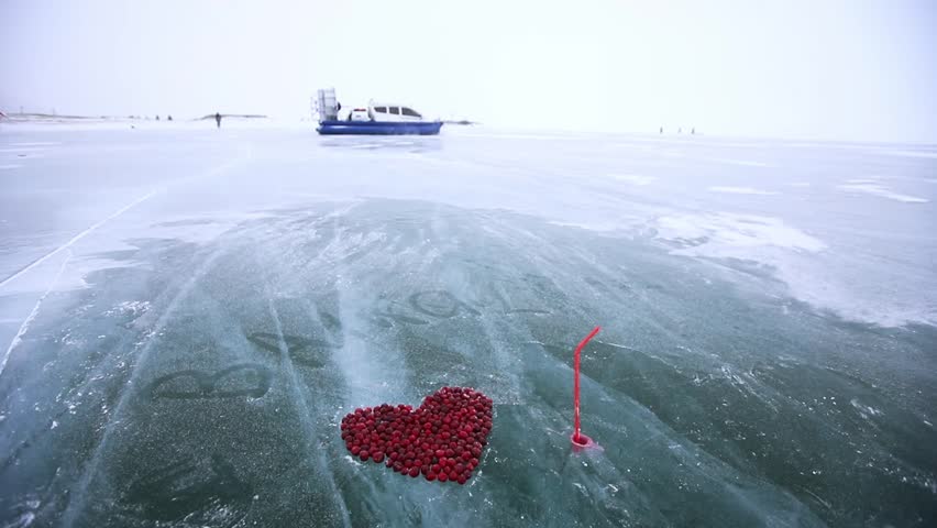 Aerial journey over baikal lake's frozen surface with heartshaped red rope art.