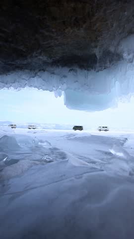 Adventurers journey across frozen lake baikal in snowy landscape.