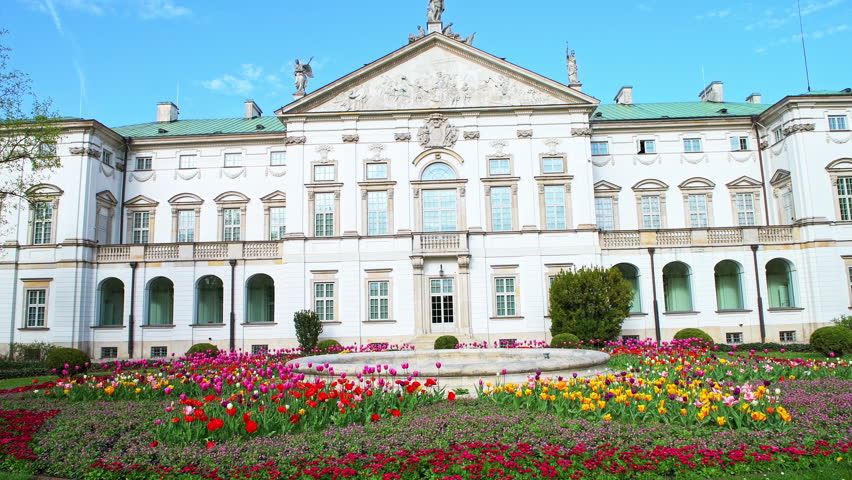 Krasinski park garden palace in Warsaw, Poland at spring with landscaped flowers bed lawn, green grass by building exterior