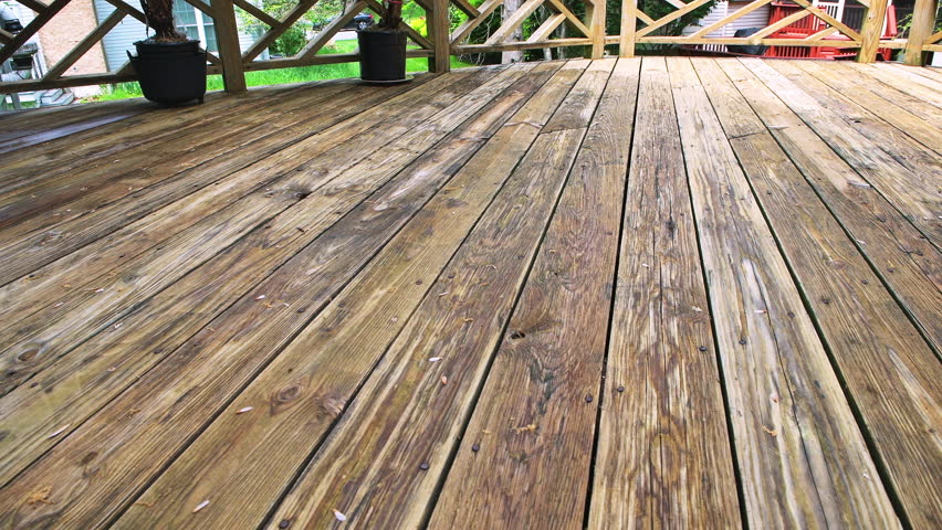 Wooden deck, weathered dirty wood planks at residential home house exterior potted plants, flower pots outside outdoors garden