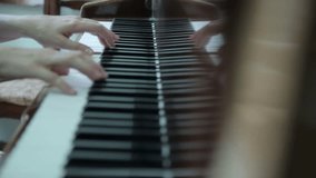 A person's hand plays a unique piano keyboard integrated into vibrant artificial green grass. This creative musical installation blends art and nature, perfect for outdoor events. - Powered by Shutterstock - Get 15% off with code: PIKWIZARD15