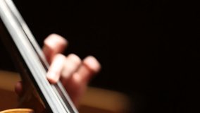 A close-up shot captures a cellist's hand expertly bowing the strings of a classical cello. The detailed shot highlights the intricate technique and the subtle vibrations of the strings during a music - Powered by Shutterstock - Get 15% off with code: PIKWIZARD15