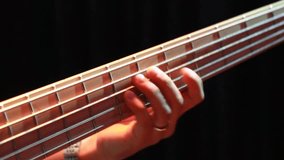 A musician's hand expertly presses strings on a bass guitar fretboard. The detailed close-up highlights skilled finger work and the instrument's design. Perfect for showcasing musical talent and rhyth - Powered by Shutterstock - Get 15% off with code: PIKWIZARD15