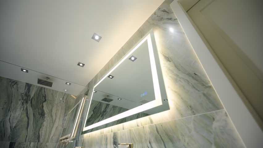 Wide shot of elements of the Modern Bathroom. Fancy walls with mirror in the modern bathroom.
