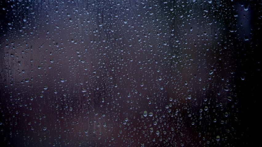 Drops of rain sliding down slowly on window glass, rainstorm, rainy season, 