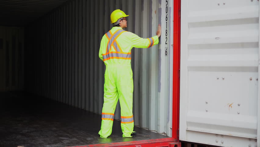 asian engineer Repair and maintenance  inside containers box in Shipping Cargo Container Terminal Depot . Container yard worker checking quality control at container yard warehouse.