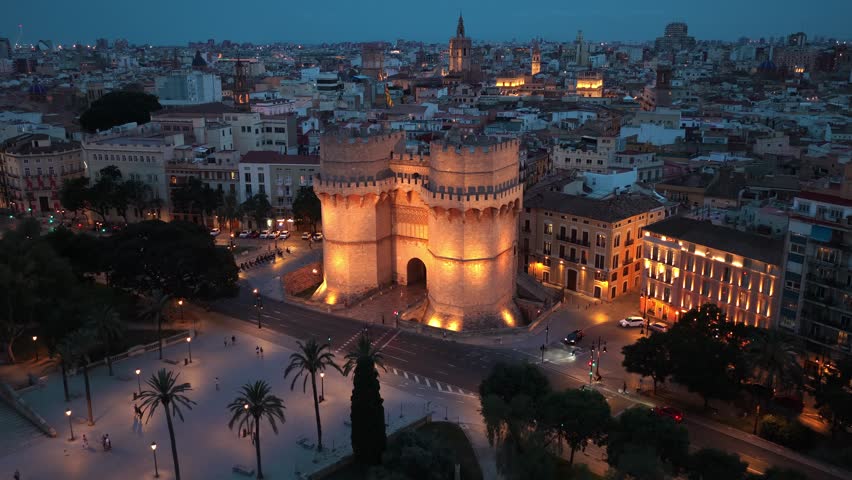 night drone view of Valencia, Torres de Serranos in Valencia at night with illumination, tourism in Valencia, Spain, Spanish travel destination in Catalunya