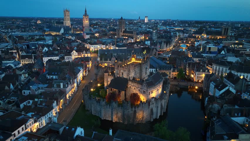 Ghent historic Belgian town, night drone shot of a medieval castle in Belgium with night illumination, tourism in the Netherlands