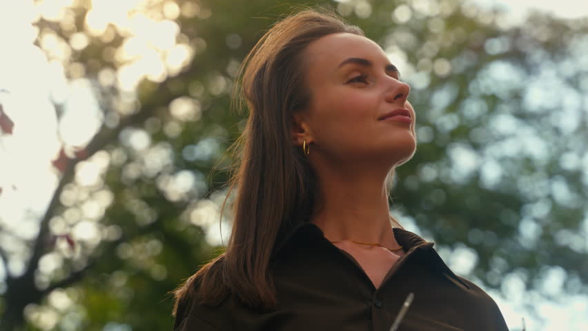 Stylish happy Caucasian woman put on dark glasses wearing sunglasses businesswoman female girl at street autumn city looking around enjoying weather healthy cheerful smiling outdoors fashion style