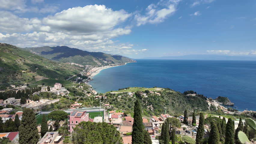 Panoramic coastal view of Taormina and Isola Bella, Sicily, Italy