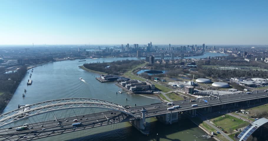 city view on Rotterdam skyline from a distance, SOuth Holland, The Netherlands, Nieuwe Maas river, solar panel on water. Aerial video