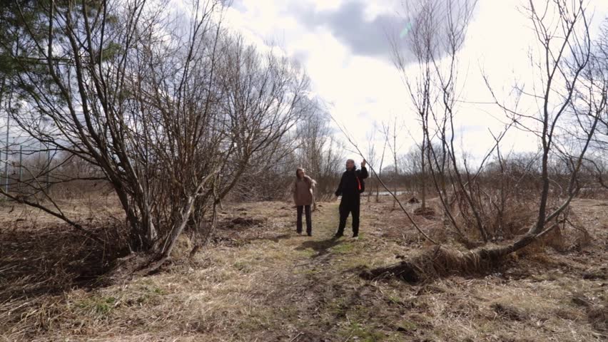 Cloudy weather hike along rural riverbank path.