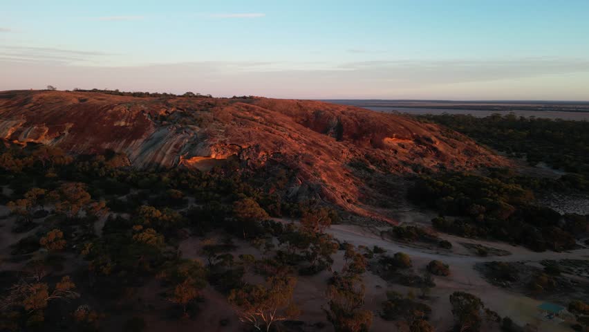 Baladjie, Western Australia, Australia. 06-17-2025. An aerial view of a rocky granite outcrop Baladjie Nature reserve Western Australia with the morning sun creeping over its contours.