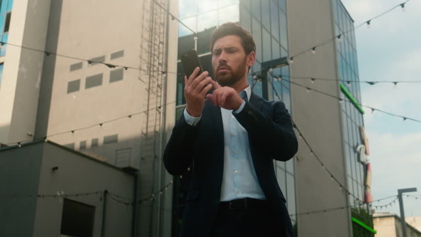 Caucasian middle-aged businessman adult business man male guy entrepreneur angry irritated trying call with mobile phone failure connection error Wi-Fi lost broken smartphone bad signal in sunny city