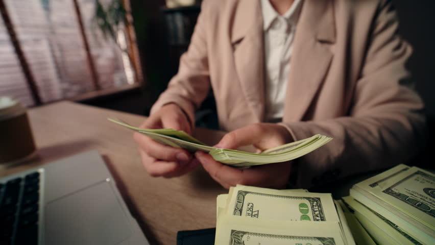 Close up unrecognizable Caucasian business woman female freelancer girl rich successful businesswoman wealthy accountant winner counting money cash wage dollars salary laptop device prize win office