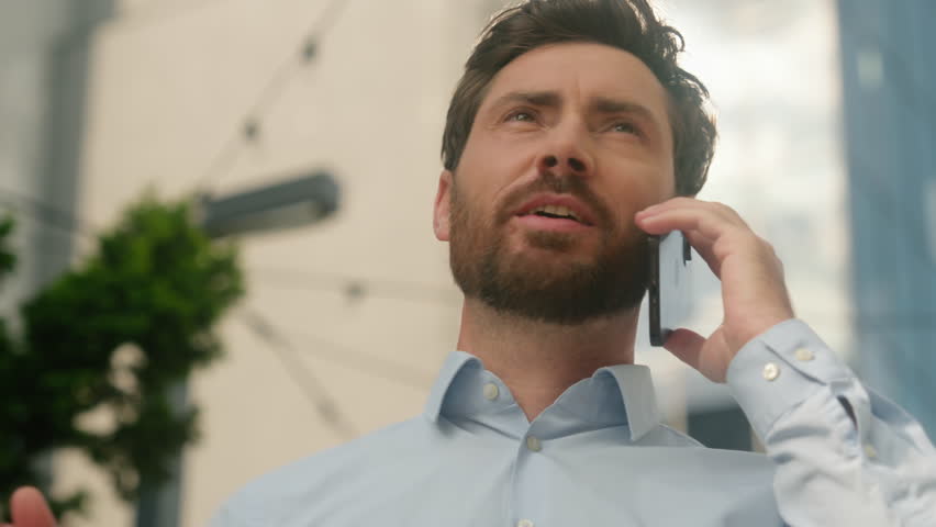 Successful worker adult Caucasian businessman employer 40s trader urban developer business man male manager banker middle-aged talking mobile phone negotiate call smartphone in city sunny guy sun