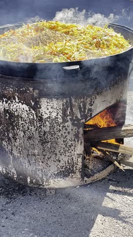 Uzbek pilaf. A dish of rice with lamb meat, cooked in a huge cauldron over a fire.