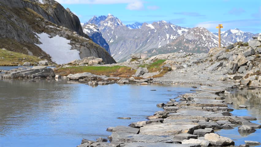 Beautiful hiking trail across reflection lake in the Alps - Col de la Vanoise in the French Alps