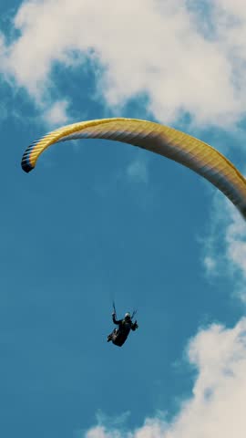 Summer Skydiving: Solo Paraglider Floating Against Clear Blue Sky