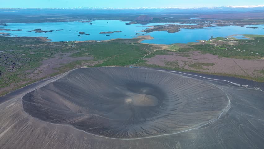 Explore the breathtaking Hverfell Volcano, an iconic natural wonder in Iceland surrounded by serene lakes and lush greenery.
