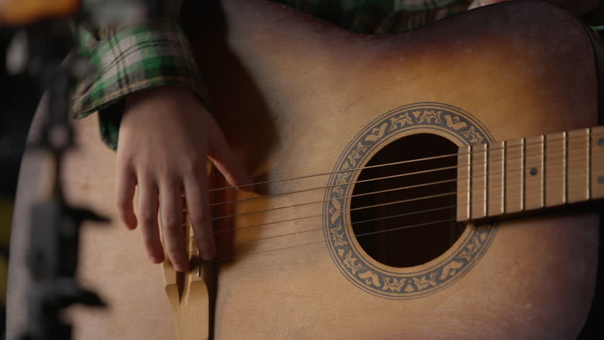 Close up Caucasian child kid guitarist little girl singer playing guitar talent schoolgirl teenager talking singing play musical instrument music song record blog vlog tutorial lesson home apartment