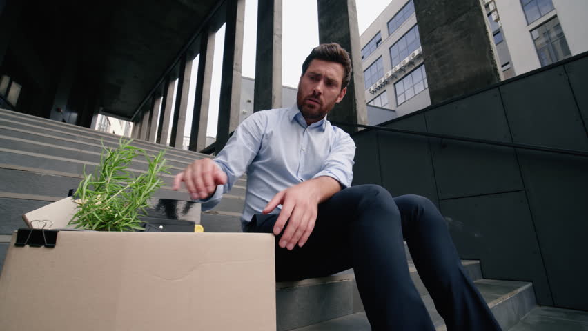 Upset middle-aged man male holding putting dismissal box on stairs bankruptcy concept mature businessman lost job frustrated business dismissed unemployment fired work economic crisis bankrupt in city