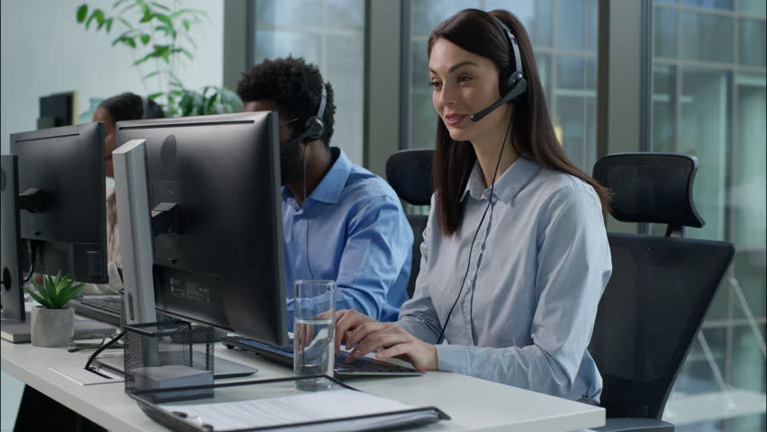 Smiling working Caucasian call center operators businesswoman talking helpline headset typing computer pc African American business man speak support customer Indian woman consulting client callcenter - Powered by Shutterstock - Get 15% off with code: PIKWIZARD15