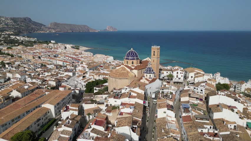 Aerial view from a drone of Altea’s old town and iconic blue-domed church overlooking the Mediterranean Sea. Picturesque coastal village on Spain’s Costa Blanca.