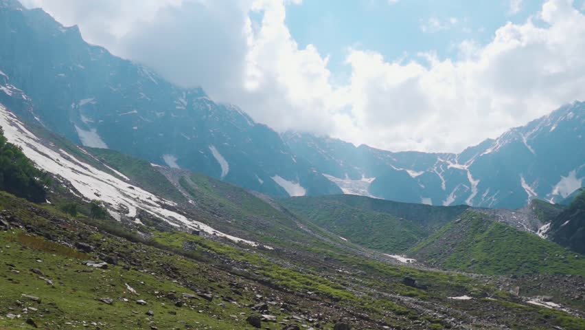 View of High Himalayan mountain range as seen from Beas Kund Trek in Himachal Pradesh, India. Summer landscape of Pir Panjal Mountain range. Nature background. Travel and holidays concept.
