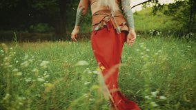 young happy fantasy blonde woman queen runs walks in green summer nature flowering field forest trees. Candid girl princess Back rear view fluttering skirt red boho dress waving, slow motion video 4k. - Powered by Shutterstock - Get 15% off with code: PIKWIZARD15