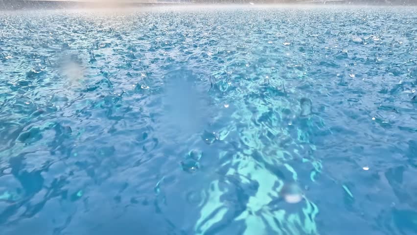 Raindrops falling in the swimming pool. Clean swimming pool.