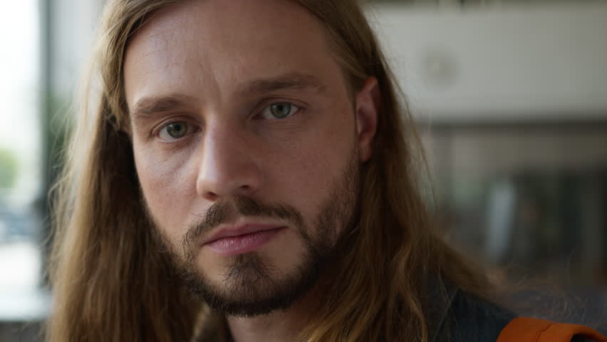 Caucasian pensive student guy man male thinking thoughtful look away serious face expression looking at camera in college university portrait problem trouble stress thoughtful headshot study education