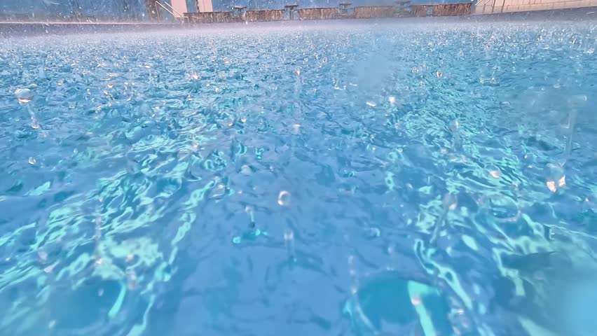 Raindrops falling in the swimming pool. Clean swimming pool.