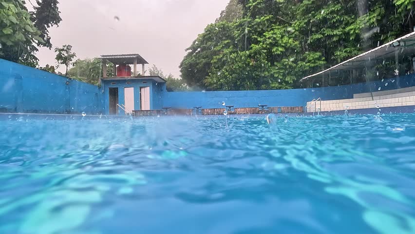 Raindrops falling in the swimming pool. Clean swimming pool.