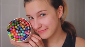 Teen girl holding colorful markers at home – creative crafting close-up - Powered by Shutterstock - Get 15% off with code: PIKWIZARD15