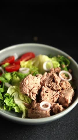Tuna salad green leaf lettuce, canned tuna, tomato fresh delicious gourmet food background on the table rustic food top view copy space keto and paleo diet vegetarian food pescetarian diet