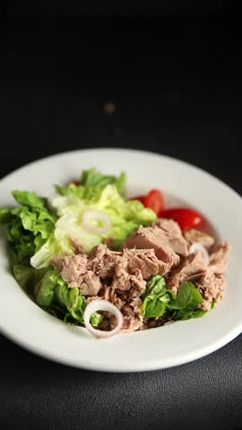 Tuna salad green leaf lettuce, canned tuna, tomato fresh delicious gourmet food background on the table rustic food top view copy space keto and paleo diet vegetarian food pescetarian diet