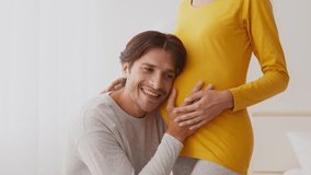 Expecting parents share a joyful moment during pregnancy in cozy setting - Powered by Shutterstock - Get 15% off with code: PIKWIZARD15