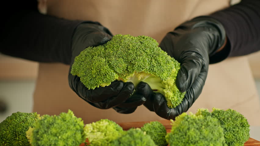 Healthy chef preparing fresh broccoli in eco-friendly kitchen setting