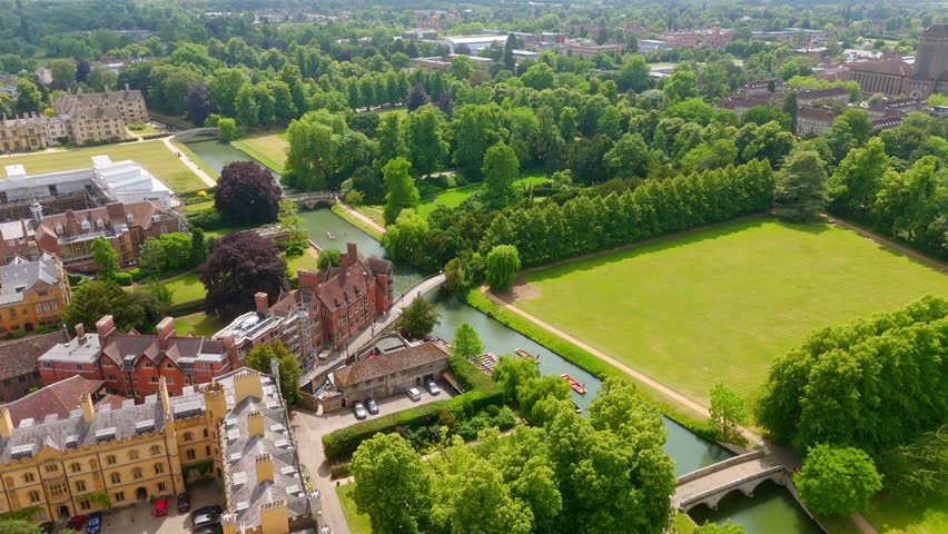 Aerial view of punting on the River Cam and the green meadows of Cambridge University on a summer day, UK