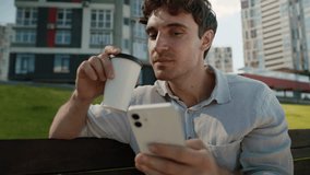 Confused puzzled Caucasian man on bench using mobile phone smartphone shocked male reading news city guy student drinking coffee break businessman business outdoor social media message wonder online - Powered by Shutterstock - Get 15% off with code: PIKWIZARD15