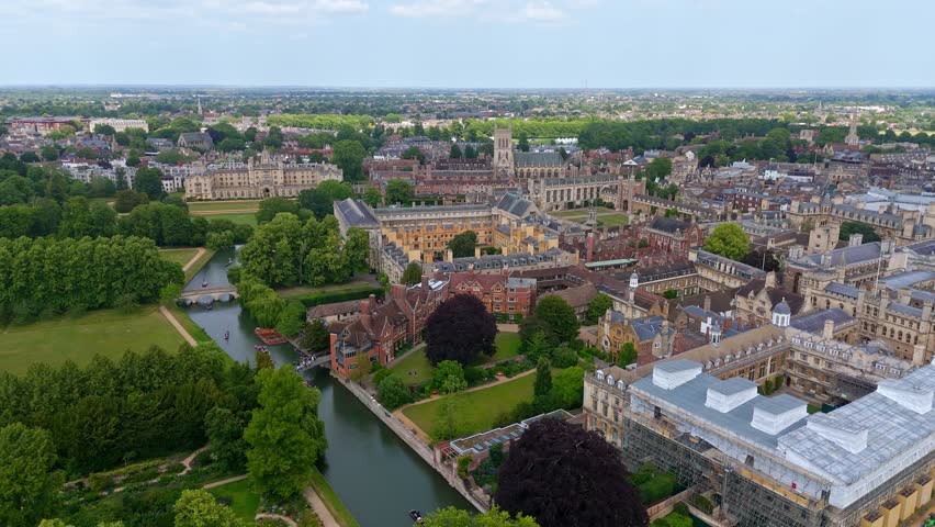 Aerial view of the historic Cambridge University campus, showcasing its traditional architecture, the river Cam, and green spaces