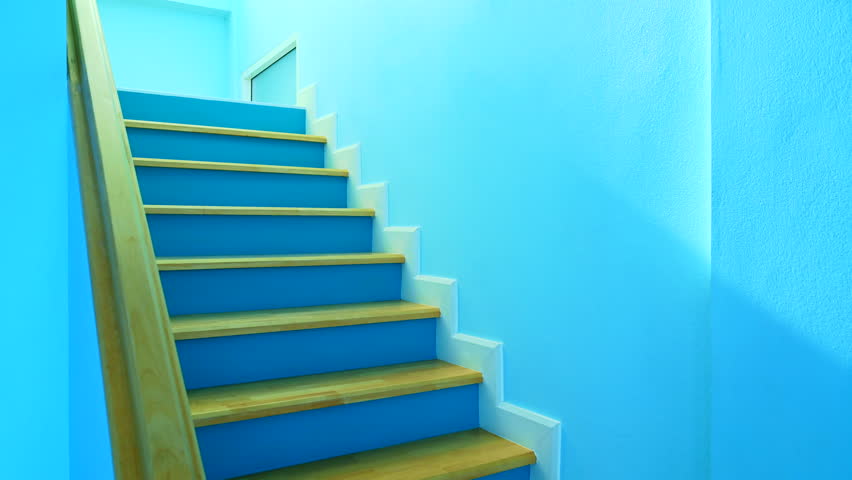 Home Decoration Series : Timelapse footage of a wooden and brightly colored staircase in a modern house. Blue stairwell of a minimalist house. Shadow changes over time in the stairway corridor.