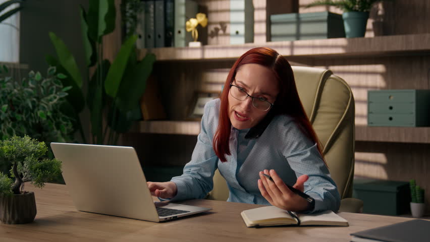 Caucasian busy woman business entrepreneur overworked manager in office female girl businesswoman stress deadline tasks online work laptop notebook writing multitasking talk mobile phone call problem